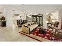 Elegant living room featuring a chandelier, ornate furniture, and a view to the backyard at 23817 S Harmony Way, Sun Lakes, AZ 85248
