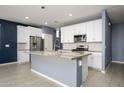 Modern kitchen with white cabinets and granite island at 12568 W Orangewood Ave, Glendale, AZ 85307