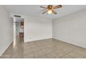 Simple bedroom with tile flooring, ceiling fan, and neutral colored walls at 2064 S Farnsworth Dr # 43, Mesa, AZ 85209