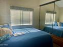 Comfortable bedroom with mirrored closet and window at 7750 E Broadway Rd # 761, Mesa, AZ 85208