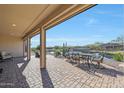 Spacious covered patio overlooking a serene pond with seating area at 16866 S 180Th Ave, Goodyear, AZ 85338