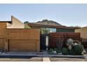 Modern home with wood and metal siding, attached garage, and desert landscaping at 6525 E Cave Creek Rd # 6, Cave Creek, AZ 85331