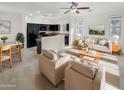 Open concept living room and kitchen with modern appliances and furnishings at 1842 N 77Th Gln, Phoenix, AZ 85035