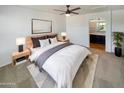 Main bedroom with en-suite bathroom and ceiling fan at 1842 N 77Th Gln, Phoenix, AZ 85035