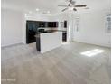 Open living room and kitchen area with dark cabinetry and neutral colors at 1842 N 77Th Gln, Phoenix, AZ 85035