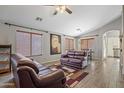 Living room with hardwood floors, leather couches, and a dining area view at 46001 W Tucker Rd, Maricopa, AZ 85139