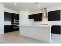 Modern kitchen with dark cabinetry, white quartz countertops, and herringbone backsplash at 3636 W Summerside Rd, Laveen, AZ 85339