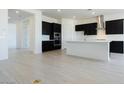 Open-concept kitchen and living area with light wood-look tile flooring at 3636 W Summerside Rd, Laveen, AZ 85339