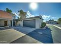 Attached garage with dark gray door at 2416 W Caribbean Ln # 1, Phoenix, AZ 85023