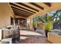 Covered entryway with terracotta tile flooring and wooden door at 3044 Ironwood Rd, Carefree, AZ 85377