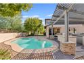 Inviting kidney shaped pool with a pergola and an outdoor kitchen area at 3346 E Coconino Dr, Gilbert, AZ 85298