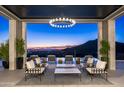 Relaxing patio with stunning sunset views, comfortable seating, and a pool at 20958 N 112Th St, Scottsdale, AZ 85255