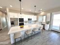 Modern kitchen with white cabinets, stainless steel appliances, and a large island at 1716 W Lucky Ln, Queen Creek, AZ 85144