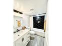 Modern bathroom with hexagon tile, white vanity, and a tub shower combo at 18202 N Cave Creek Rd # 149, Phoenix, AZ 85032