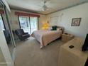 Bright bedroom with a queen bed, sliding door to patio, and mirrored closet at 3927 N Indiana Ave, Florence, AZ 85132