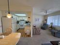 Open kitchen with light cabinets and laminate floor at 3927 N Indiana Ave, Florence, AZ 85132
