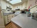 Kitchen with white cabinets, laminate counters and stove at 3927 N Indiana Ave, Florence, AZ 85132
