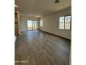 Spacious living area with tile floors and sliding glass doors at 7066 E Drygulch Rd, San Tan Valley, AZ 85143