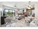 Open living area showcasing a modern kitchen, island, and comfortable seating near sliding glass doors at 377 E Windsor Ave # 21, Phoenix, AZ 85004