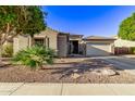 House exterior showcasing desert landscaping and a two-car garage at 13506 W Earll Dr, Avondale, AZ 85392