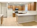 Modern kitchen with wood cabinets and quartz countertops at 15685 W Mackenzie Dr, Goodyear, AZ 85395