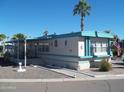 Mobile home with carport, steps and mature landscaping at 201 S Greenfield Rd # 197, Mesa, AZ 85206