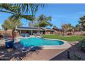 Inviting backyard oasis featuring a sparkling pool and lush grass at 362 Ancora S Dr, Litchfield Park, AZ 85340