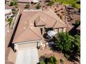 Single-story home with tile roof, courtyard, and two-car garage at 41906 W Solitare Dr, Maricopa, AZ 85138