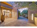 Elegant entryway with stone walls and glass doors at 6301 N 51St Pl, Paradise Valley, AZ 85253