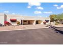 Exterior view showing a light-colored house with a red awning and landscaping at 7810 E Vista Dr, Scottsdale, AZ 85250