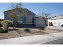 House exterior with a two-car garage and nicely landscaped yard at 30893 W Pinchot W Ct, Buckeye, AZ 85396