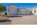 Three-car garage with herringbone driveway at 11250 W Prospector Dr, Queen Creek, AZ 85144