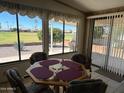 Dining area with a view of a golf course from large windows at 2548 N Trevino N Pl, Mesa, AZ 85215