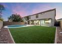 Backyard oasis with a swimming pool and artificial turf at 15163 W Cameron Dr, Surprise, AZ 85379