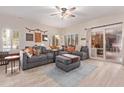 Spacious living room with gray sectional sofa and wood floors at 3047 E Fremont Rd, Phoenix, AZ 85042