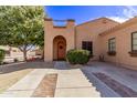 Front view of charming house with brick walkway and landscaping at 3047 E Fremont Rd, Phoenix, AZ 85042