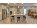Island kitchen with white cabinets and breakfast area at 27552 W Tonopah Dr, Buckeye, AZ 85396