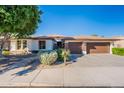 House exterior featuring a two-car garage and well-manicured landscaping at 7778 S Grandview Ave, Tempe, AZ 85284