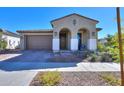 Single-story home with arched entryway and two-car garage at 9515 E Rainbow Ave, Mesa, AZ 85212