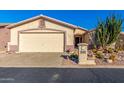 Desert landscape surrounds this single-story home with a two-car garage at 2101 S Meridian Rd # 172, Apache Junction, AZ 85120