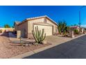 View of the home's exterior, showcasing the garage and desert landscaping at 2101 S Meridian Rd # 172, Apache Junction, AZ 85120