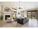 Spacious living room featuring a fireplace, large windows, and comfortable seating at 16349 E Links Dr, Fountain Hills, AZ 85268
