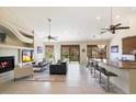 Open living area with fireplace, high ceilings, and sliding glass doors leading to a balcony at 16349 E Links Dr, Fountain Hills, AZ 85268