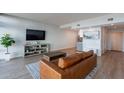 Living room with hardwood floors and a brown leather couch at 4808 N 24Th St # 306, Phoenix, AZ 85016