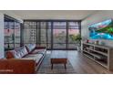 Living room with hardwood floors, large windows, and city views at 4808 N 24Th St # 306, Phoenix, AZ 85016