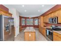 Bright kitchen with wood cabinets, stainless steel appliances, and an island at 19926 N Organ Pipe Dr, Surprise, AZ 85374
