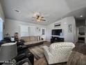 Spacious living room featuring a comfortable seating arrangement and wood-look flooring at 650 N Hawes Rd # 3314, Mesa, AZ 85207
