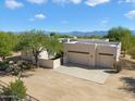 Aerial view of a stucco home with a double garage and mountain views at 14428 E Monument Dr, Scottsdale, AZ 85262