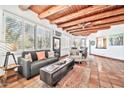 Open floor plan living room with wood beam ceilings and tile floors at 9252 E Whitethorn Cir, Scottsdale, AZ 85266