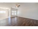 Spacious living room with wood-look floors and ceiling fan at 11465 E Florian Ave, Mesa, AZ 85208